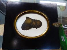 AN OVAL SILHOUETTE ON PLASTER BY MIERS AND FIELD OF A GENTLEMAN, THE DETAILS PICKED OUT IN GILDING