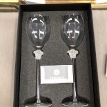 A BOXED PAIR OF VERSACE WINE GLASSES.