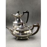 A HALLMARKED SILVER TEAPOT WITH WOODEN HANDLE AND FINIAL, SIGNED ASPREY LONDON, TOGETHER WITH A