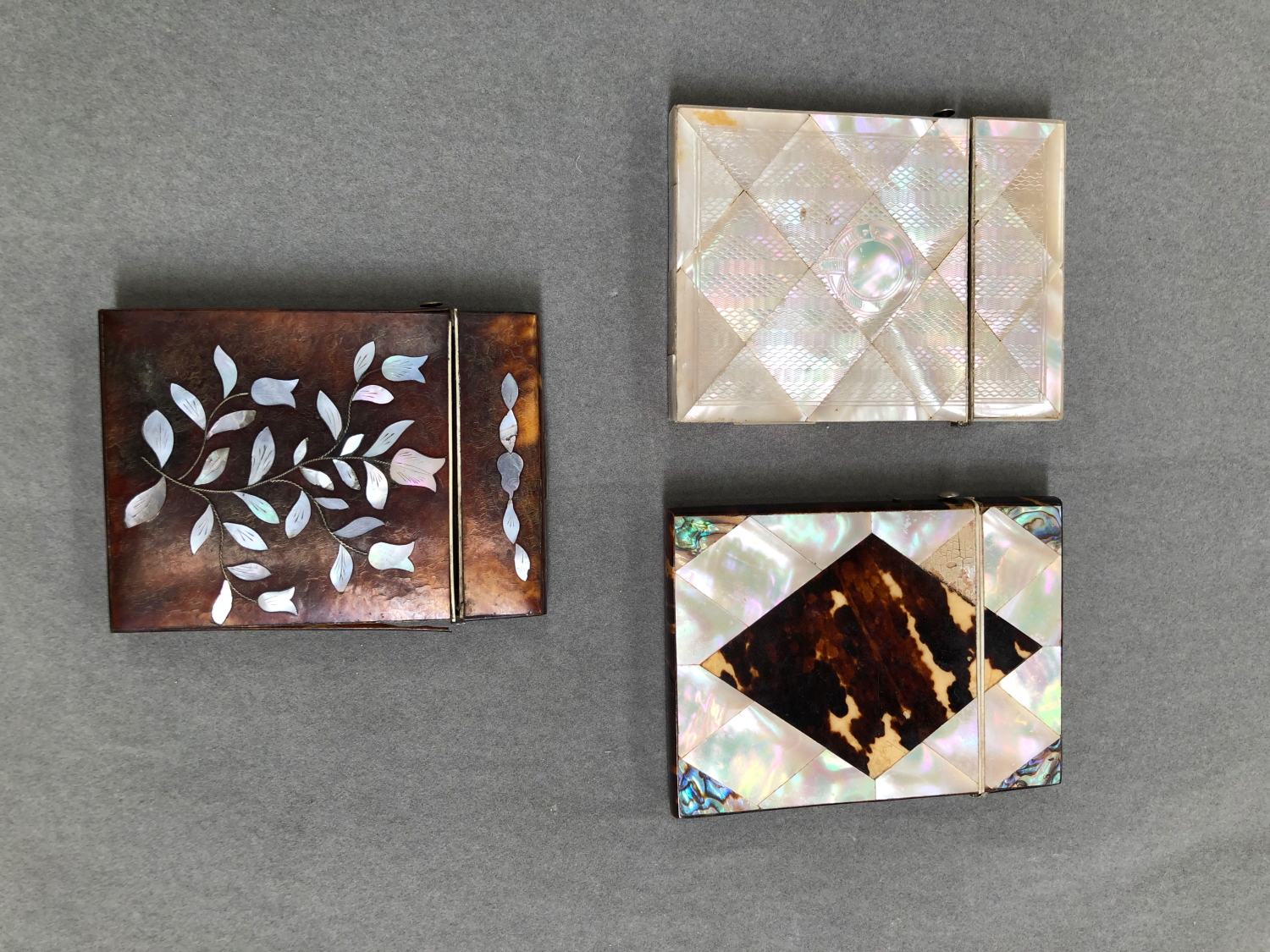 TWO MOTHER OF PEARL MOUNTED CARD CASES, AND AN INLAID TORTOISESHELL EXAMPLE.