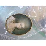 A PORTRAIT MINIATURE OF AN 18TH CENTURY LADY WITH GREY POWDERED HAIR, THE GILT OVAL FRAME WITH