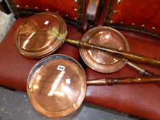 THREE ANTIQUE COPPER WARMING PANS.