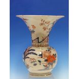 A JAPANESE IMARI VASE, THE FLARED NECK PAINTED WITH A FENCED GARDEN THE COMPRESSED SPHERICAL BODY