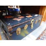 A VINTAGE BLUE CABIN TRUNK WITH IRON PROTECTED CORNERS AND OLD LABELLING. W 91cms.