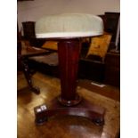 A VICTORIAN MAHOGANY PIANO STOOL ON HEXAGONAL COLUMN TAPERING TO A TRIPARTITE PLINTH AND BUN FEET