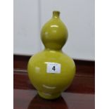 AN ORIENTAL DOUBLE GOURD VASE WITH YELLOW GLAZE.