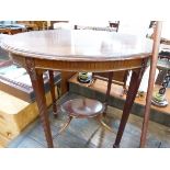 AN EDWARDIAN MAHOGANY OVAL TWO TIER TABLE WITH FLUTED APRON AND TAPERING SQUARE LEGS. W 77cms.