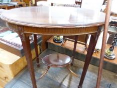 AN EDWARDIAN MAHOGANY OVAL TWO TIER TABLE WITH FLUTED APRON AND TAPERING SQUARE LEGS. W 77cms.