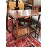 A MAHOGANY TABLE, THE GALLERIED LOWER TIER JOINING RING TURNED CYLINDRICAL LEGS. W 57 x D 41 x H