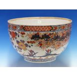 AN 18th C. JAPANESE IMARI BOWL PAINTED ON THE EXTERIOR WITH A FLOWERIUNG CHERRY TREE AND WITH