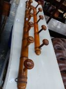 TWO ROWS OF VINTAGE COAT HOOKS, THE SIMULATED BAMBOO BACKS SUPPORTING FIVE AND SEVEN PEGS RESPECT