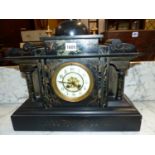 A GREEN MARBLE INSET BLACK SLATE CASED STRIKING CLOCK, THE DIAL WITH ARABIC NUMERALS BELOW A CUPOLA