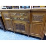 AN WALNUT LATE VICTORIAN BREAKFRONT SIDEBOARD WITH CARVED DOORS AND DRAWERS. W 151 x D 51 x H 95cms.