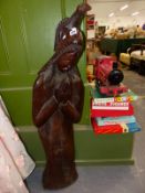 A VINTAGE CARVED HARD WOOD STATUETTE.