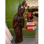 A VINTAGE CARVED HARD WOOD STATUETTE.