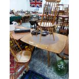 AN ERCOL TEAK ROUNDED SQUARE EXTENDING DINING TABLE AND THREE CHAIRS, THE TABLE. W 125 x D 112 x H