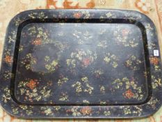 A 19th C. ROUNDED RECTANGULAR PAPIER MACHE TRAY DECORATED WITH RED AND GREEN FLOWERS ON THE BLACK