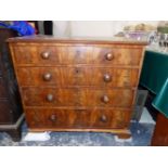 A GEORGIAN WALNUT CHEST OF FOUR GRADED DRAWERS ON BRACKET FEET