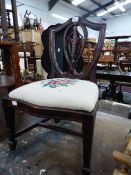 A CHILDS MAHOGANY SHIELD BACK CHAIR WITH PINK ROSE NEEDLE WORK SERPENTINE FRONTED SEAT ABOVE