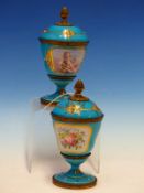 A PAIR OF ORMOLU MOUNTED SEVRES STYLE JEWELLED TURQUOISE GROUND COVERED GOBLETS PAINTED ON ONE