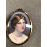 AN ANTIQUE MINIATURE PORTRAIT PAINTING OF A GIRL SIGNED JOHN MOSLEY 1910, WITH A BRASS FRAME.