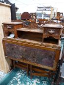 AN OAK DROP FLAP WRITING TABLE, THE SHELF BACK FLANKED BY MASK HANDLED DRAWERS OVER SHELVES, THE