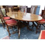 A LINE INLAID REGENCY STYLE MAHOGANY OVAL DINING TABLE SUPPORTED ON FOUR COLUMNS ON A PLINTH AND FOU