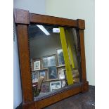 A 19TH CENTURY RECTANGULAR MIRROR IN AN ARTS AND CRAFTS FRAME INLAID WITH FRUITING VINES AND WITH SQ