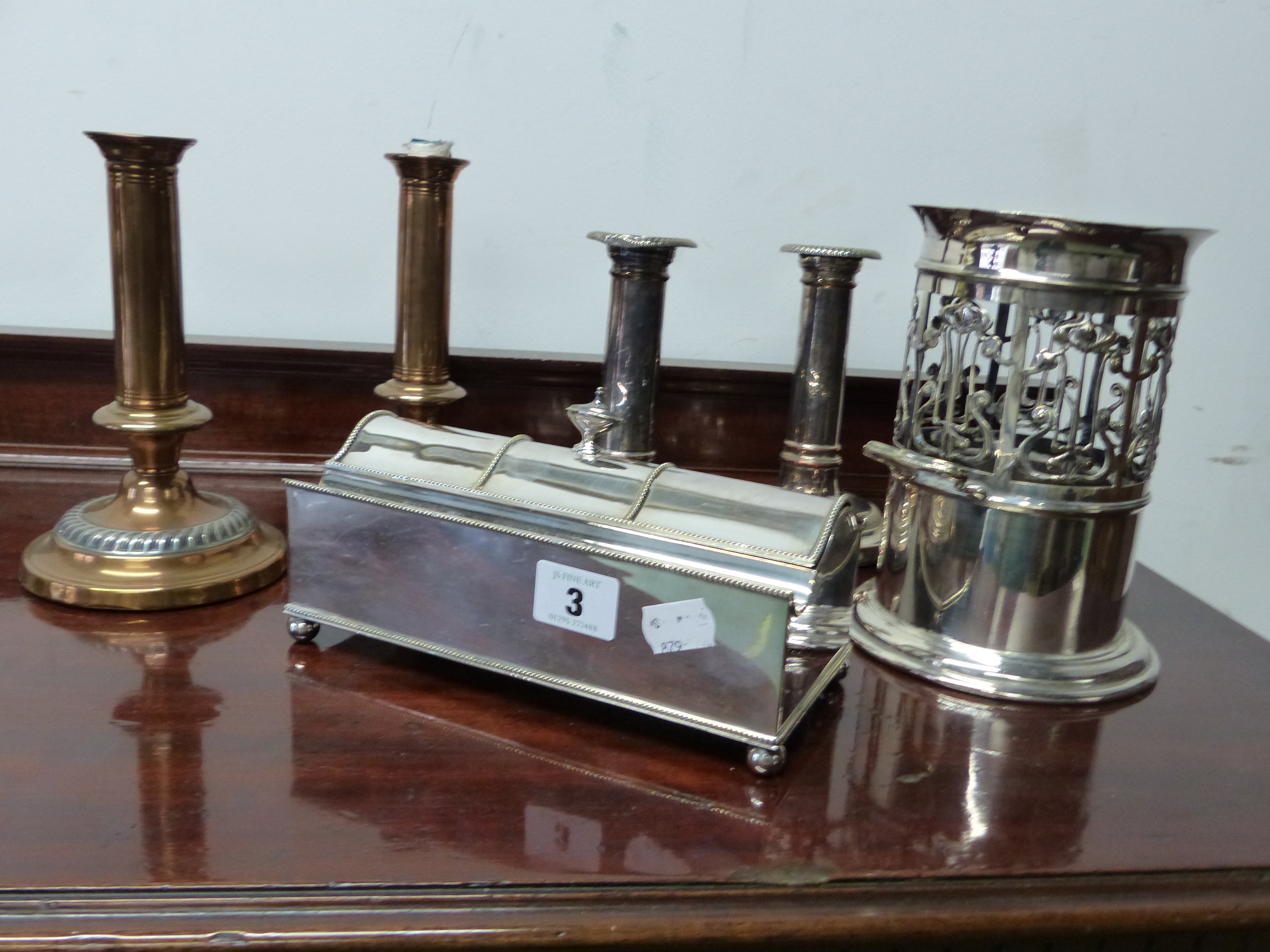 AN ART NOUVEAU BOTTLE STAND, 2 PAIRS OF SILVER PLATED CANDLESTICK AND A PLATED DESK STAND.