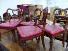 A SET OF FIVE VICTORIAN MAHOGANY BALLOON BACK CHAIRS WITH RED SEATS ABOVE TAPERING CYLINDRICAL FRONT