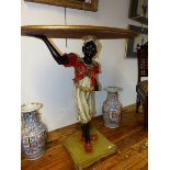 A CARVED GILT OVAL TABLE SUPPORTED BY A HAND AND THE TURBANNED HEAD OF A BLACKAMOOR FIGURE WEARING