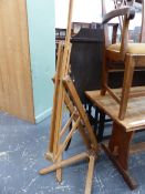 AN ARTISTS EASEL ADJUSTABLE AND FOLDING ABOVE WISH BONE LEGS