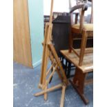 AN ARTISTS EASEL ADJUSTABLE AND FOLDING ABOVE WISH BONE LEGS