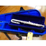 A FLUTE WITH CASE AND A SMALL VIOLIN CASE.