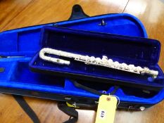 A FLUTE WITH CASE AND A SMALL VIOLIN CASE.