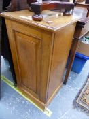 AN OAK BEDSIDE CUPBOARD, THE FIELDED PANELLED DOOR ENCLOSING SHELVES. W 40 x D 36 x H 79cms.