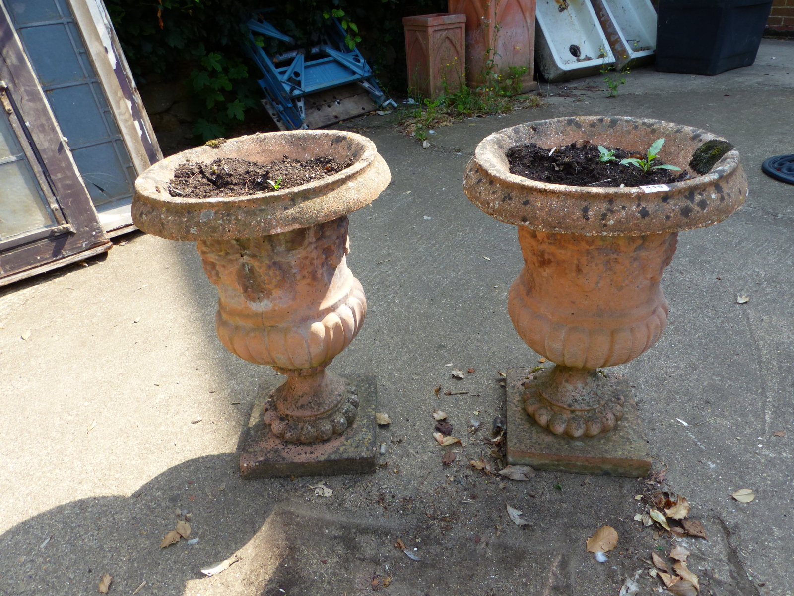 A PAIR OF COMPOSITE CLASSICAL STYLE GARDEN URNS.