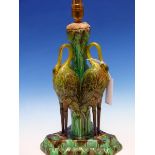 A 19th C. MAJOLICA TABLE LAMP, THE FOLIATE COLUMN SUPPORTED BY THREE STORKS STANDING ON THE