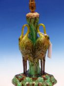 A 19th C. MAJOLICA TABLE LAMP, THE FOLIATE COLUMN SUPPORTED BY THREE STORKS STANDING ON THE