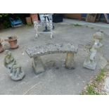 A COMPOSITE PEDESTAL GARDEN SEAT AND TWO GARDEN FIGURES.