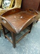 A MAHOGANY OVAL BUTLERS TRAY TOPPED ON LATER COFFEE TABLE STAND