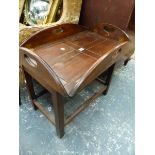 A MAHOGANY OVAL BUTLERS TRAY TOPPED ON LATER COFFEE TABLE STAND