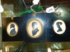 THREE OVAL SILHOUETTES, ONE OF THE TWO PORTRAITS OF GENTLEMEN WITH GILT DETAILS, THAT OF THE LADY