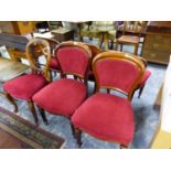 A MATCHED SET OF SIX VICTORIAN MAHOGANY BALLOON BACKED CHAIRS UPHOLSTERED IN RED