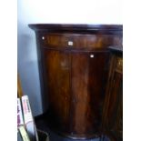 A GEORGE IV BOW FRONT MAHOGANY CORNER CABINET. W 90 X D 63 X H 118CMS.