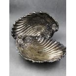 A PAIR OF HALLMARKED SILVER LARGE SHELL FORM THREE FOOTED DISHES. DATED 1909 FOR HARRISON BROTHERS &