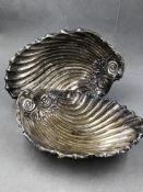 A PAIR OF HALLMARKED SILVER LARGE SHELL FORM THREE FOOTED DISHES. DATED 1909 FOR HARRISON BROTHERS &