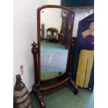 A VICTORIAN MAHOGANY FRAMED FULL LENGTH CHEVAL MIRROR, THE REEDED COLUMNS TOPPED BY CABOCHON ORNAMEN