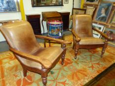 A PAIR OF LEATHER UPHOLSTERED TEAK COLONIAL TEA PLANTATION CHAIRS, THE FLAT ARMS WITH SWING OUT UNDE