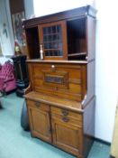 A MID VICTORIAN SIDE CABINET, THE GLAZED DOOR CENTRAL TO SHELVING ABOVE A FOUR PANELLED FALL FRONT